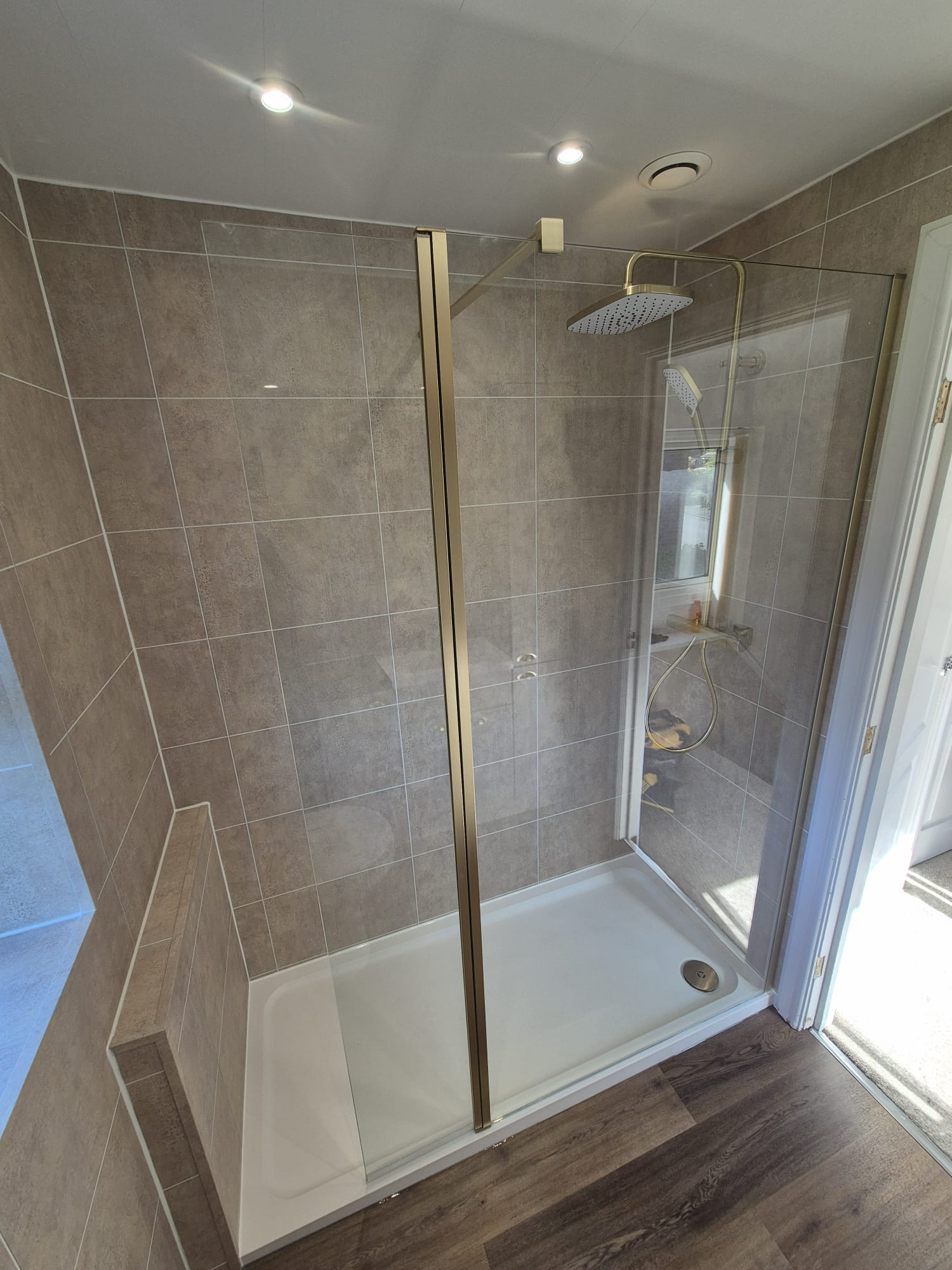 Large walk-in shower with bench and rainfall head — recent project