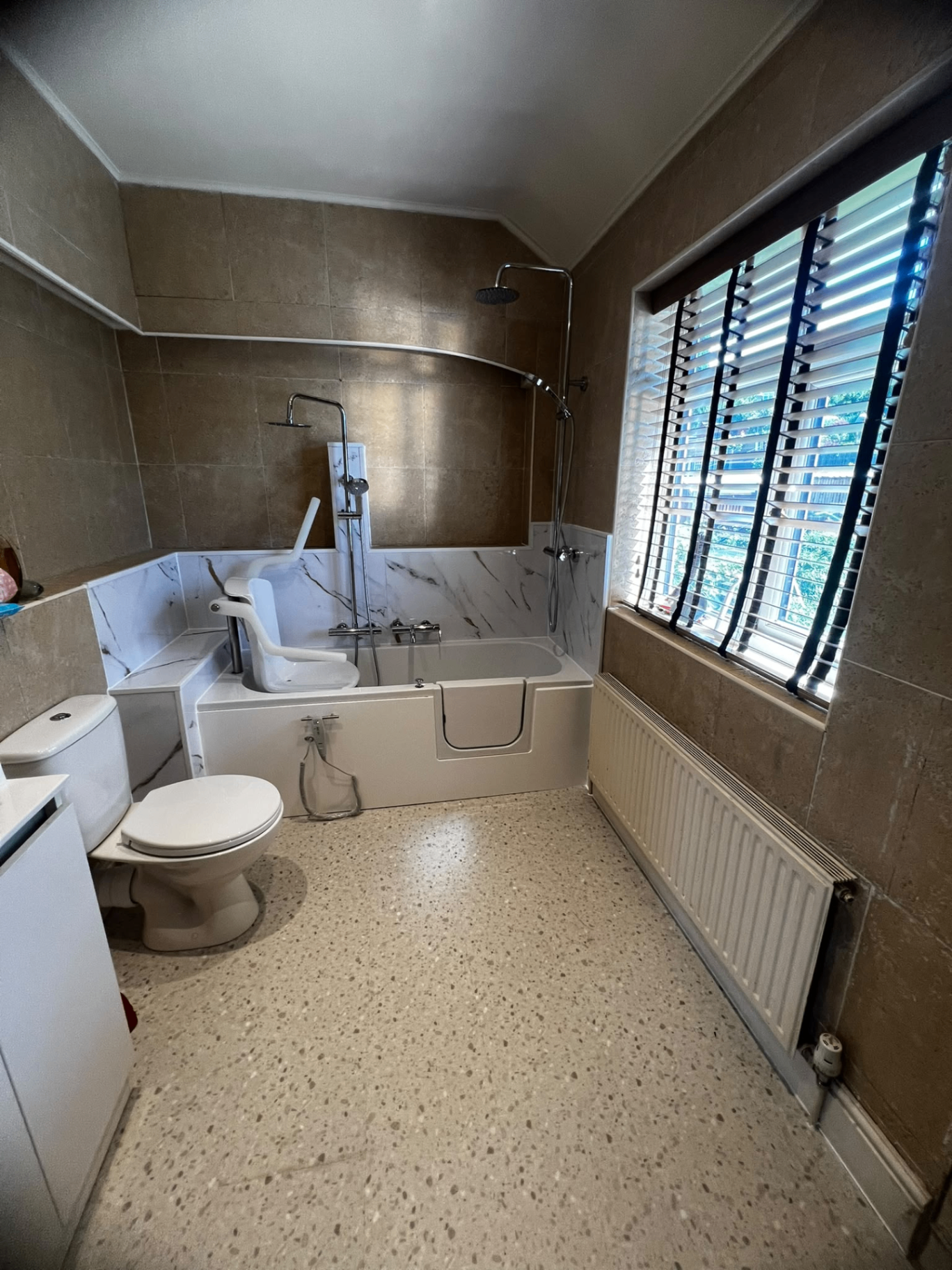 Walk-in bath with marble splashback and rainfall shower — recent project